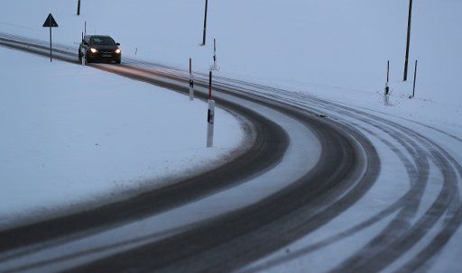 27 February 2020, Bavaria, Marktoberdorf: Tire tracks appear on a snow-covered road. Photo: Karl-Josef Hildenbrand\/
