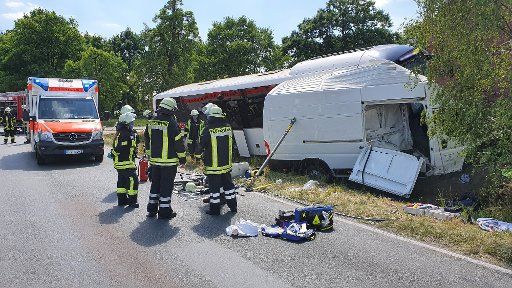 18 May 2020, Lower Saxony, Ostercappeln: A transporter and a public service bus lie next to a road in a ditch In a collision with a public service bus in Ostercappeln in the district of Osnabrück, the driver of a transporter was fatally injured. According to initial findings, the man had overlooked the bus at an intersection on Monday. The bus driver and a passenger suffered minor injuries. Photo: Ulf Zurlutter\/Nord-West-Media TV \/