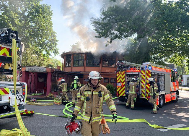 21 May 2020, Lower Saxony, Oldenburg: The fire brigade extinguishes a fire in a Mexican restaurant located on a traffic island. The fire caused extensive property damage. No one was injured, a police spokesman said. Photo: -\/Nord-West-Media TV \/