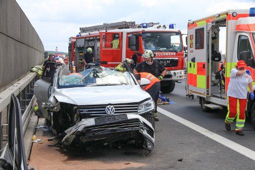 22 June 2020, Bavaria, Forchheim: Rescue workers are working at an accident site on highway 73, where the two trapped passengers had to be freed from the wreckage by the fire brigade with heavy equipment after the accident. They had filmed their own rescue from the vehicle with their smartphones. Photo: Ferdinand Merzbach