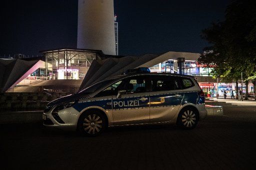 07 August 2020, Berlin: A police car is parked in front of the TV tower. One person died and another was injured during a clash at Berlin\