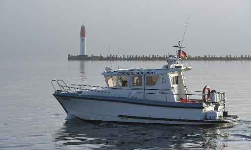 13 October 2020, Mecklenburg-Western Pomerania, Stralsund: A boat with the lettering "Fischereiaufsicht" (Fisheries Inspectorate) drives through the harbour. Photo: Stefan Sauer\/dpa-Zentralbild\/ZB