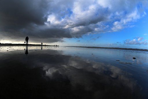 22 October 2020, Lower Saxony, Juist: Clouds pass over the North Sea island of Juist and are reflected in the waters of the North Sea. Photo: Federico Gambarini\/dpa