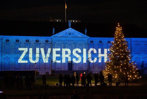 15 December 2020, Berlin: Federal President Frank-Walter Steinmeier and his wife Elke Büdenbender watch as numerous images and messages are projected onto the façade of Bellevue Palace to mark the launch of the "Lichtblick" project. From 15 to 17 December 2020, the façade of Bellevue Palace will be illuminated with an artistic light projection showing messages sent in by people from all over Germany. With this "ray of hope", President Steinmeier wants to send a signal of encouragement and cohesion at the end of this special year marked by the Corona pandemic. Photo: Bernd von Jutrczenka\/dpa
