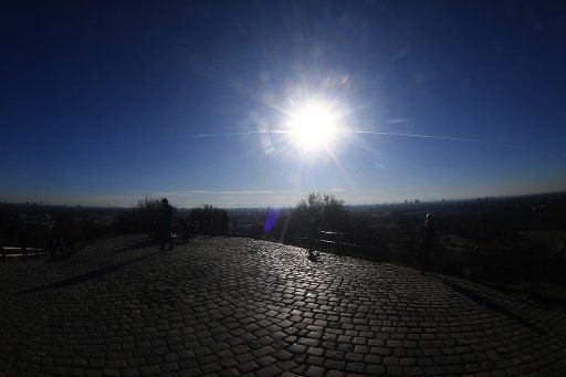 18 December 2020, Bavaria, Munich: The sun is low over the Olympiaberg. Photo: Felix Hörhager\/dpa