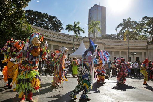 28 December 2020, Venezuela, Caracas: Artists dance in costume as part of the traditional folk festival "Locos y Locainas". Photo: Ernesto Vargas\/dpa