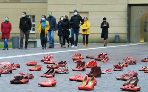 25 November 2020, Brandenburg, Potsdam: Members of the Landtag walk past red women\