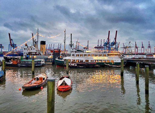 31 December 2020, Hamburg: Boats and ships are moored in the museum harbour of Oevelgönne near or opposite the container terminal Burchardtkai. Photo: Soeren Stache\/dpa-Zentralbild\/ZB