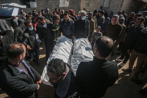 07 March 2021, Palestinian Territories, Khan Yunis: Relatives carry the bodies of two of the three Palestinian fishermen during their funeral after they were killed by an explosion off the coast of the southern Gaza Strip. The chairman of the Fishermen\