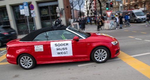 11 March 2021, Bavaria, Munich: A sign reading "Söder must go!" is stuck to a car during a motorcade rally. Photo: Peter Kneffel\/dpa
