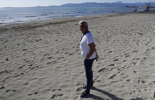 14 March 2021, Spain, Palma: Nico from Berlin stands on the beach of Arenal. Due to the low incidence of the coronavirus, Mallorca is no longer a risk area. Photo: Clara Margais\/dpa