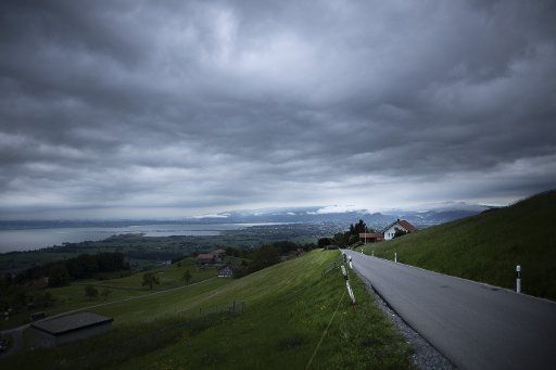 13 May 2018, Switzerland, Wolfhalden: Dark clouds are drifting from Lake Constance (left in the photo) over one of the access roads to Wolfhalden (Switzerland) into the Alps. Photo: Alexander Prautzsch\/dpa-Zentralbild\/ZB