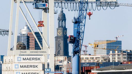 25 December 2020, Hamburg: Container cranes of the Hansa harbour, the Kehrwiederspitze and the tower of the main church St. Michaelis form the skyline of the Hanseatic city of Hamburg. Photo: Markus Scholz\/dpa