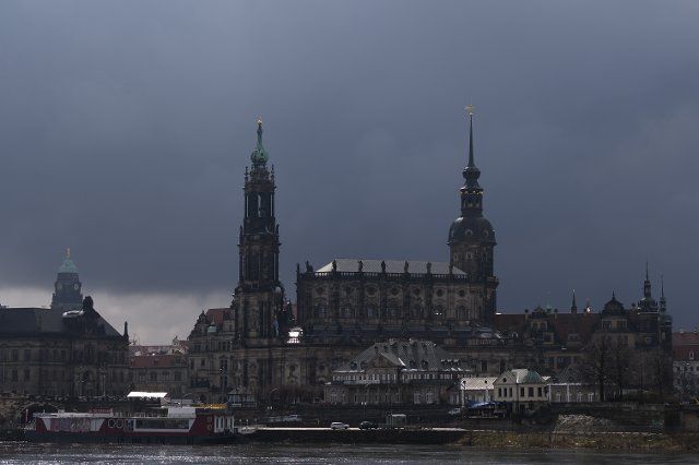19 March 2021, Saxony, Dresden: Dark clouds drift along behind the backdrop of the Old Town with the Town Hall Tower (l-r), the Catholic Court Church and the Castle Tower. Photo: Sebastian Kahnert\/dpa-Zentralbild\/dpa