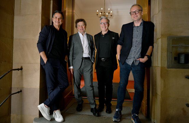 25 June 2021, Baden-Wuerttemberg, Stuttgart: The artistic directors of the Staatstheater Stuttgart, Tamas Detrich (l-r, ballet), Stuttgart, Viktor Schoner (opera), Marc- Oliver Hendriks (managing artistic director) and Burkhard C. Kosminski (drama) and stand in an entrance to the theatre during a photo session. During a press conference, they present their plans for the next season. Photo: Bernd Weissbrod\/dpa