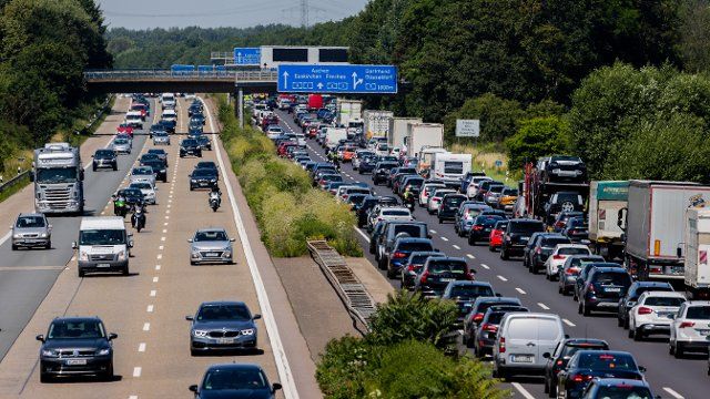 03 July 2021, North Rhine-Westphalia, Cologne: Cars are jammed on the A4 motorway in the direction of Aachen. The summer holidays have begun in North Rhine-Westphalia. Photo: Rolf Vennenbernd\/dpa