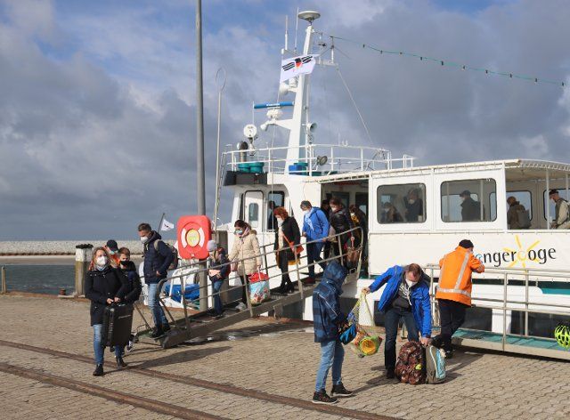 21 May 2021, Lower Saxony, Wangerooge: Visitors leaving the Jens Albrecht III ferry Tourism in Lower Saxony is picking up again. On the coast and on the islands it could already be crowded at Whitsun. Photo: Peter Kuchenbuch-Hanken\/dpa