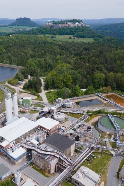 01 June 2021, Saxony, KÃ¶nigstein: Two uranium silos (l) stand on the premises of Wismut GmbH in front of KÃ¶nigstein Fortress. After 75 years, the last uranium transport has left the site. This means that Germany is no longer on the list of uranium-producing countries. (Aerial photo with drone) Photo: Sebastian Kahnert\/dpa-Zentralbild\/dpa