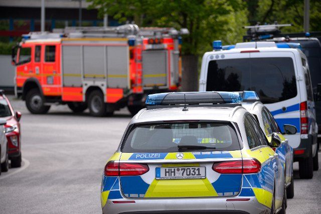 01 June 2021, Hamburg: Police patrol cars and squad cars stand in front of a fire engine of the fire department. Greenpeace activists rappelled down from the roof of the Edeka headquarters in the morning and unfurled banners. High climbers from the police and fire brigade were then deployed. Photo: Jonas Walzberg\/dpa