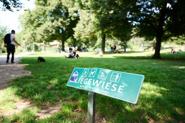 12 August 2021, Berlin: "Liegewiese" is written on the sign in the Weinbergpark in Berlin Mitte. It\