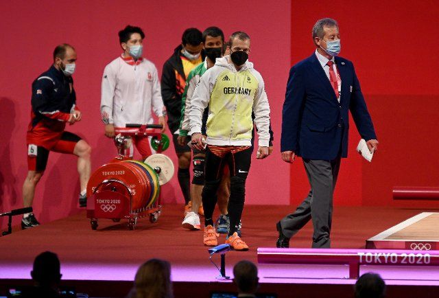 25 July 2021, Japan, Tokio: Weightlifting: Olympia , Combat up to 61 kg, men at Tokyo International Forum. Simon Brandhuber (2nd from right) from Germany arrives. Photo: Marijan Murat\/dpa