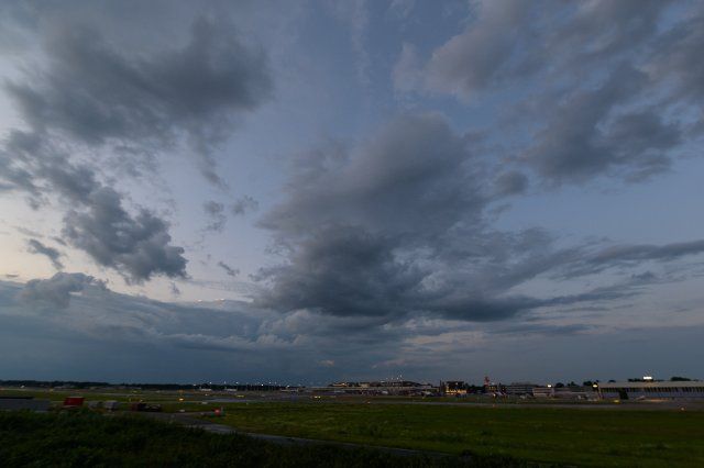 26 July 2021, Hamburg: Dark clouds move over the airport area in the direction of Schleswig-Holstein. Photo: Jonas Walzberg\/dpa