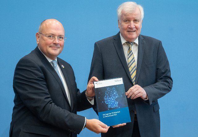 21 October 2021, Berlin: Arne Schönbohm (l), President of the Federal Office for Information Security (BSI), and Horst Seehofer (CSU), Federal Minister of the Interior, stand together at the presentation of the report on the state of IT security in Germany. Photo: Christophe Gateau\/dpa
