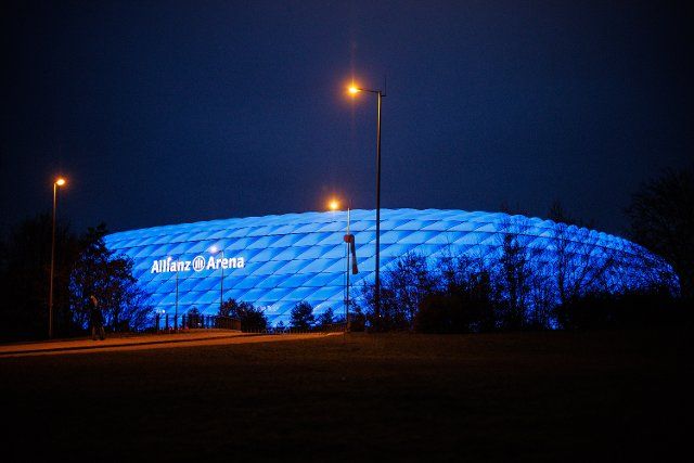 20 November 2021, Bavaria, Munich: The Allianz Arena is lit up in blue as part of a light campaign for International Children\