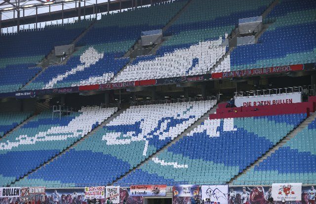 11 December 2021, Saxony, Leipzig: Football: Bundesliga, Matchday 15, RB Leipzig - Borussia Mönchengladbach at the Red Bull Arena. A stylised bull made of coloured seat shells can be seen in the empty stands. Photo: Jan Woitas\/dpa-Zentralbild\/dpa - IMPORTANT NOTE: In accordance with the regulations of the DFL Deutsche Fußball Liga and\/or the DFB Deutscher Fußball-Bund, it is prohibited to use or have used photographs taken in the stadium and\/or of the match in the form of sequence pictures and\/or video-like photo series
