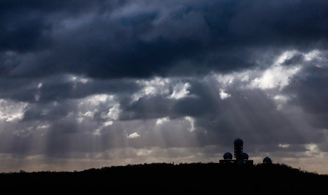 20 January 2022, Berlin: Rays of sunlight break through the clouds above the former US listening station on Teufelsberg. Photo: Hannibal Hanschke\/dpa