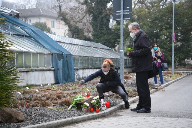 25 January 2022, Baden-Wuerttemberg, Heidelberg: A woman and a man lay flowers on the grounds of Heidelberg University. On Monday 24.01.2022 there was a rampage on campus with two dead. Photo: R.Priebe\/Pr-Video\/dpa