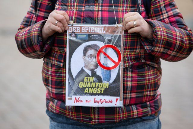 29 January 2022, Lower Saxony, Osnabrück: The cover of a counterfeit magazine from "Der Spiegel" shows a photo of German Health Minister Karl Lauterbach. Below it is a quote in reference to the supposed James Bond film "Quantum of Fear". Participants demonstrate against the current Corona measures. Photo: Friso Gentsch\/dpa