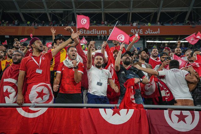 15 December 2021, Qatar, Doha: Tunisian fans cheer in the stands prior to the start of the FIFA Arab Cup semifinal soccer match between Tunisia and Egypt at Stadium 974. Photo: Ayman Aref\/dpa