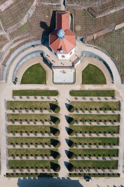 24 March 2022, Saxony, Radebeul: Gardeners work in the baroque grounds of the Saxon State Winery Schloss Wackerbarth with the Belvedere and the historic vineyards. (Aerial view with a drone) Photo: Sebastian Kahnert\/dpa-Zentralbild\/dpa