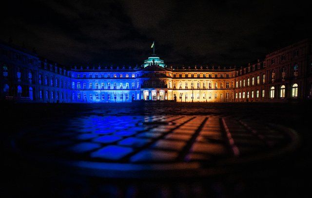24 February 2022, Baden-Wuerttemberg, Stuttgart: As a sign of solidarity, the New Castle shines in the colors of the flag of Ukraine. Photo: Christoph Schmidt\/dpa