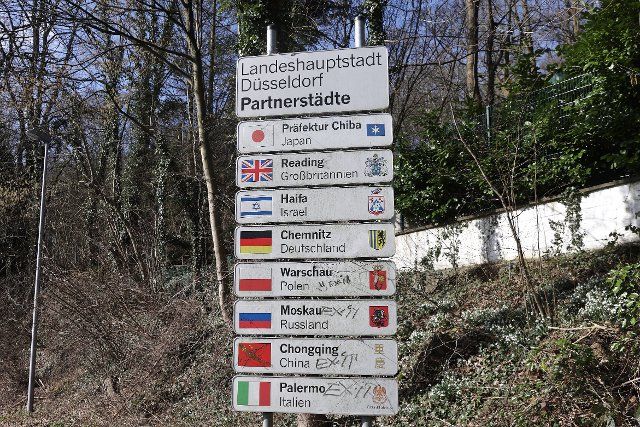 26 February 2022, North Rhine-Westphalia, Duesseldorf: On the outskirts of the capital of North Rhine-Westphalia, there is a sign indicating partnerships with other cities. Moscow is also listed. After Russia\