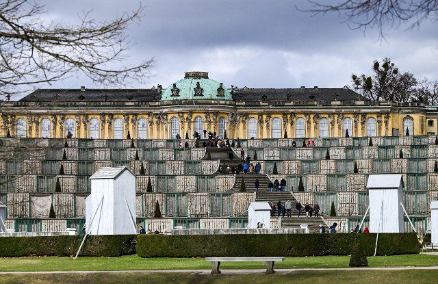 26 February 2022, Brandenburg, Potsdam: Numerous people are out and about in the cool weather on the terraces and the grand staircase in front of Sanssouci Palace. Photo: Jens Kalaene\/dpa-Zentralbild\/dpa