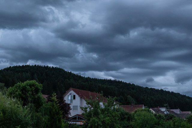 23 June 2022, Baden-Wuerttemberg, Rottweil: Dark clouds gather over a residential area near Rottweil. Photo: Silas Stein\/dpa
