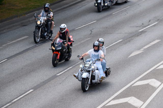 26 June 2022, Hamburg: Participants in the parade ride their motorcycles along Willy-Brandt-Strasse. In largely perfect weather, many motorcycle fans have met at Hamburg\