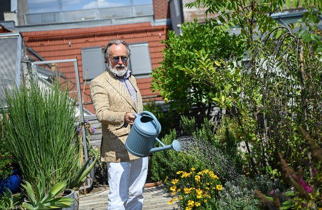 08 August 2022, Berlin: The musician and actor Friedrich Liechtenstein waters the flowers on the terrace of his apartment. His new album "Good Gastein" with songs and spoken words will be released on Aug. 19, 2022. (to dpa: Friedrich Liechtenstein: Don\
