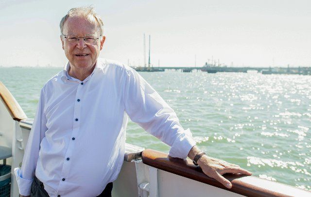 12 August 2022, Lower Saxony, Wilhelmshaven: Stephan Weil (SPD), Minister President in Lower Saxony, stands on a ship in front of the construction site for the planned LNG terminal. Weil visited the future jetty together with Lower Saxony\