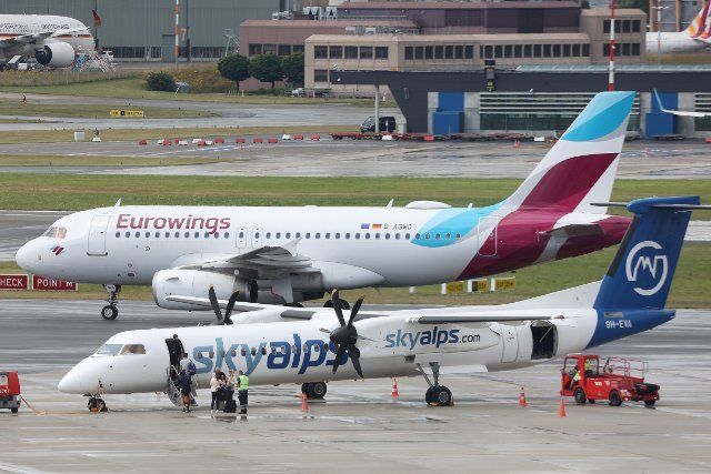 07 July 2022, Hamburg: Hamburg Airport: Aircraft of the airlines Eurowings and Skyalps are parked on the apron. Photo: Bodo Marks\/dpa\/Bodo Marks