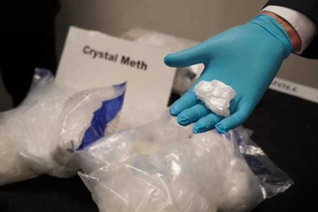 27 September 2022, Hamburg: Crystal meth is seen in bags and on a hand. (to dpa: "Customs seize 182 kilograms of crystal meth in the port of Hamburg") Photo: Frank Bründel\/Citynewstv\/dpa
