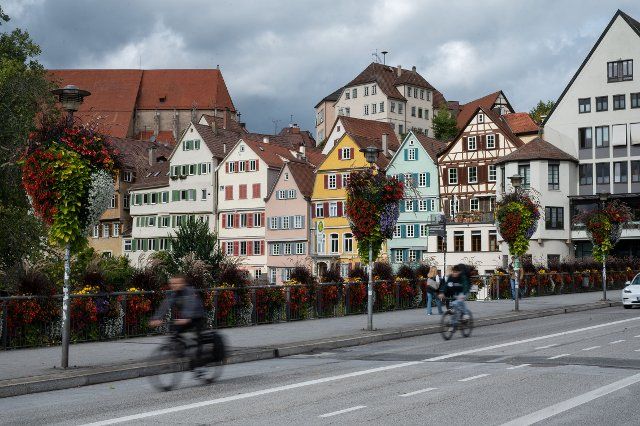 27 September 2022, Baden-Wuerttemberg, Tübingen: Cyclists ride across a bridge over the Neckar River in the city center. Two women and four men are running for mayor in Tübingen on October 23, including incumbent Palmer as an independent candidate. Photo: Marijan Murat\/dpa