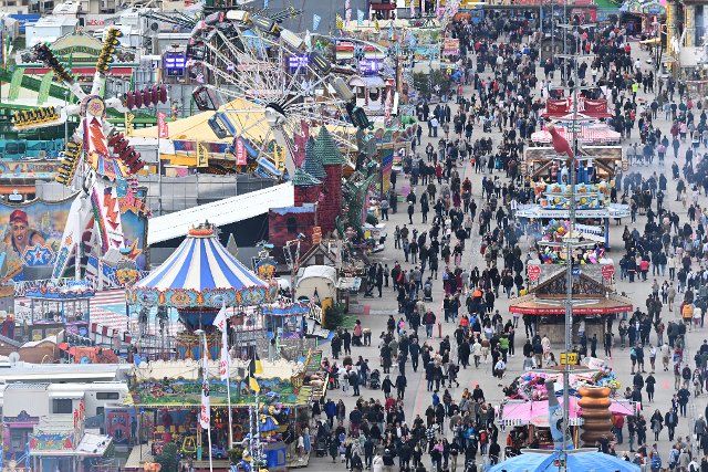30 September 2022, Bavaria, Munich: Visitors to the Wiesn and rides are seen at the Oktoberfest from the Paulskirche. The Wiesn will be held from September 17 to October 3, 2022. Photo: Felix Hörhager\/dpa