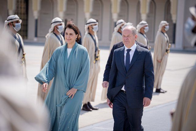 25 September 2022, United Arab Emirates, Abu Dhabi: German Chancellor Olaf Scholz (SPD) walks next to United Arab Emirates Minister of Climate Change and Environment Mariam bint Mohammed Saeed Hareb Almheiri (l) at Abu Dhabi airport to board the Air Force Airbus A340 for the onward flight to Qatar. After Saudi Arabia, the chancellor visits the United Arab Emirates and Qatar. Photo: Kay Nietfeld\/dpa