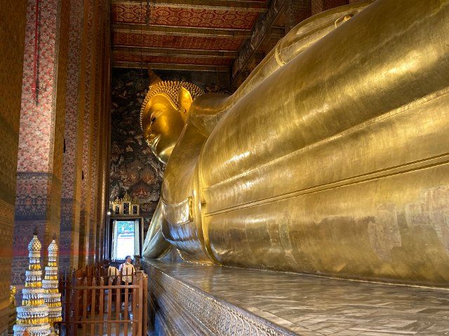 19 February 2022, Thailand, Bangkok: A golden Buddha figure is located in Wat Pho (Temple of the Reclining Buddha) and is 46 meters long and 15 meters high. The temple is one of the main sights of Bangkok. (to dpa "Temple visit until midnight: Bangkok plans longer opening hours") Photo: Carola Frentzen\/dpa