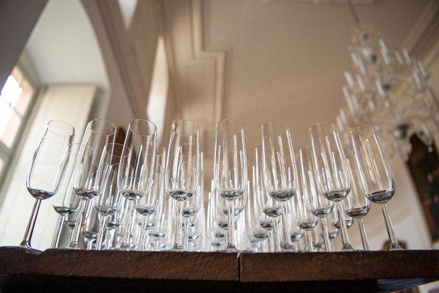 25 September 2022, North Rhine-Westphalia, Höxter: Champagne glasses stand orderly on a table. Photo: Lino Mirgeler\/dpa