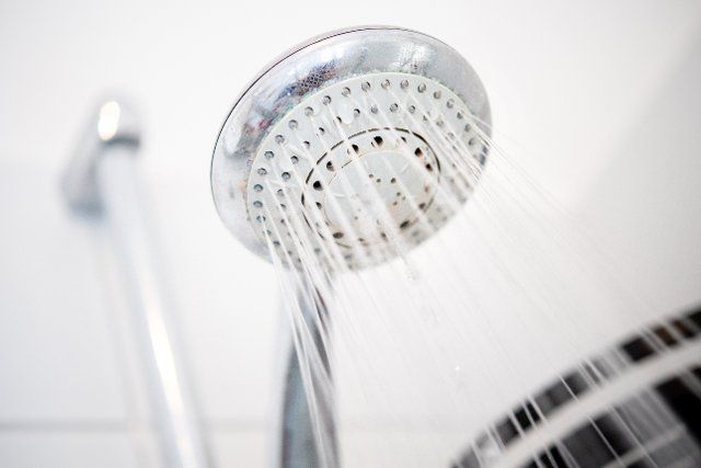 14 September 2022, Lower Saxony, Oldenburg: A shower head hangs in a shower in a bathroom. Photo: Hauke-Christian Dittrich\/dpa