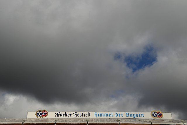 26 September 2022, Bavaria, Munich: Dark clouds can be seen over the Hacker Festival Tent, the "Bavarian Heaven" at the Oktoberfest. The Wiesn takes place from September 17 to October 3, 2022. Photo: Felix Hörhager\/dpa